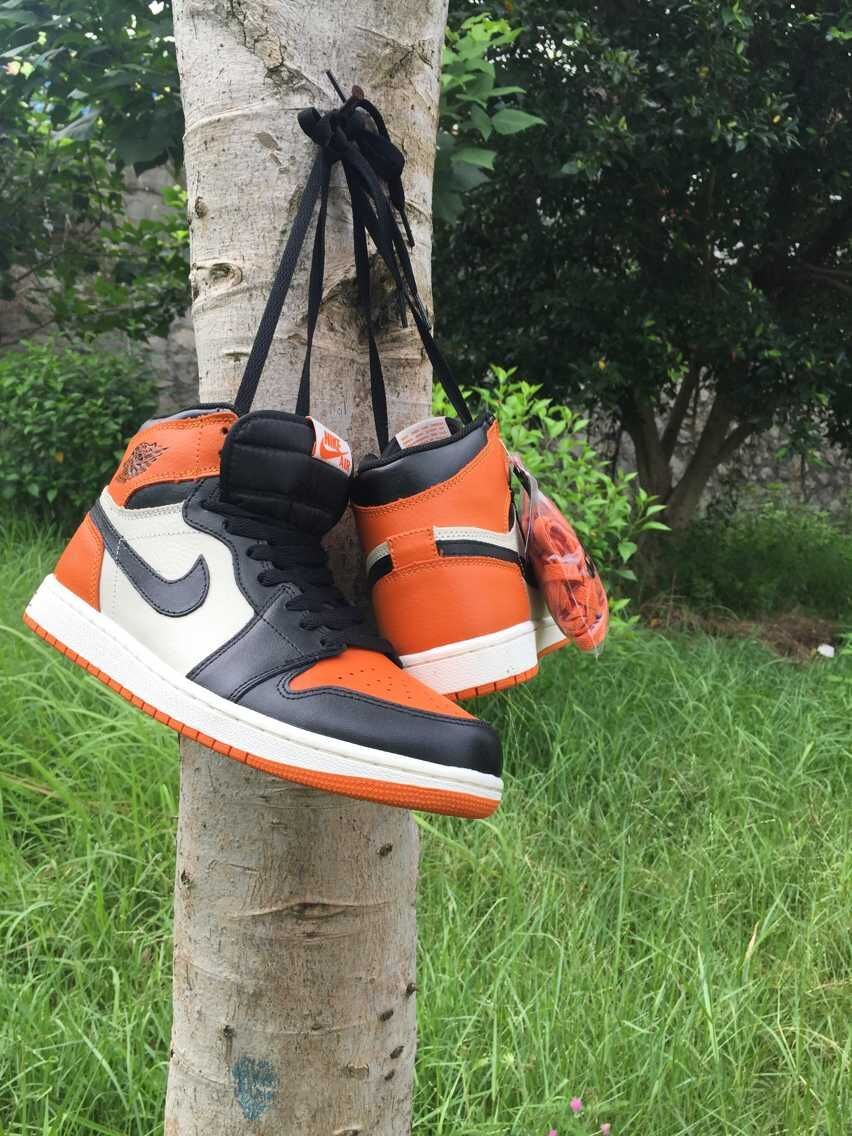 Jordan 1 High Sneakers in Black, in White and Orange - product image from the listing.