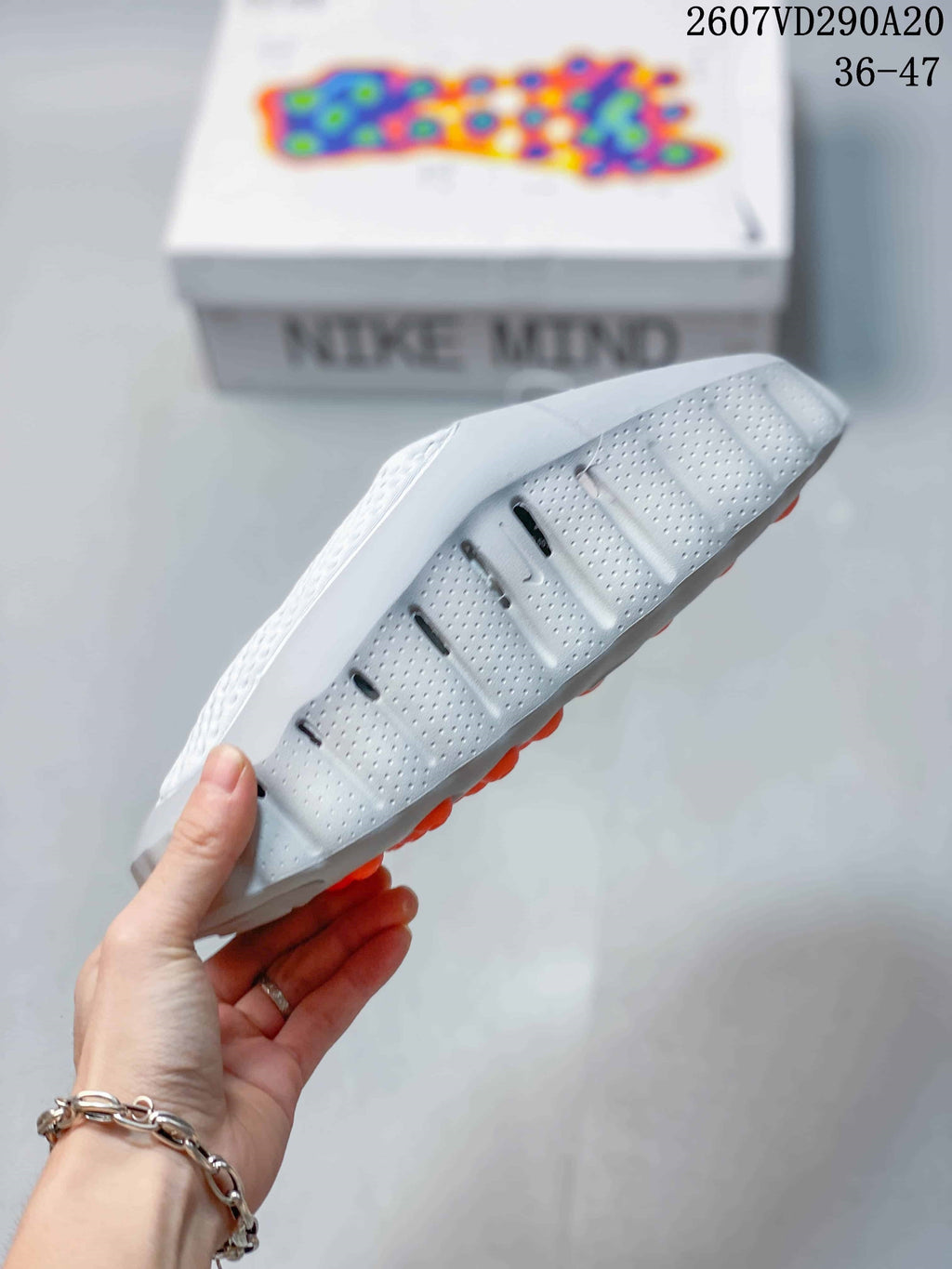 Mind 001 Slide Sandals White with Orange Pods by Nike - product image from the listing.