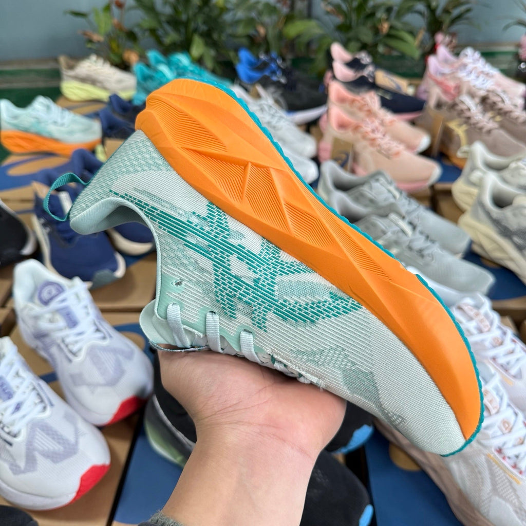ASICS NOVABLAST 5 LE Running Shoes in White Orange - product image from the listing.