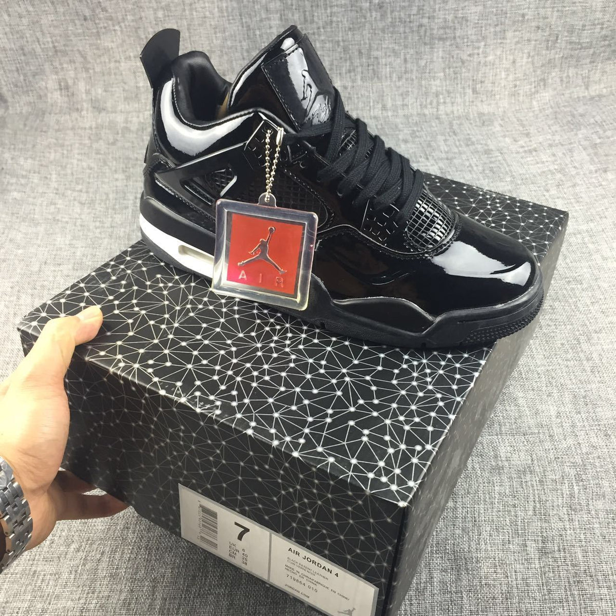 Air Jordan 4 Black Glossy Sneakers - product image from the listing.