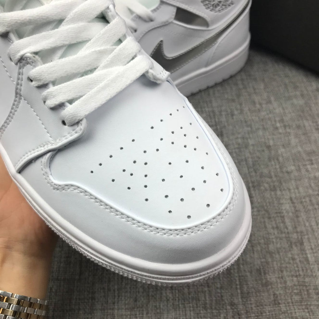Air Jordan 1 Mid Sneakers in White Silver 554724-105 - product image from the listing.