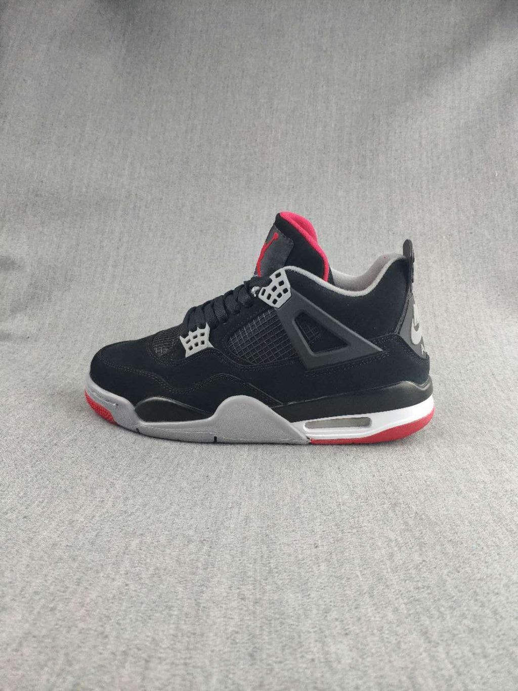 Jordan 4 Retro Sneaker in Black, in Red and White - product image from the listing.