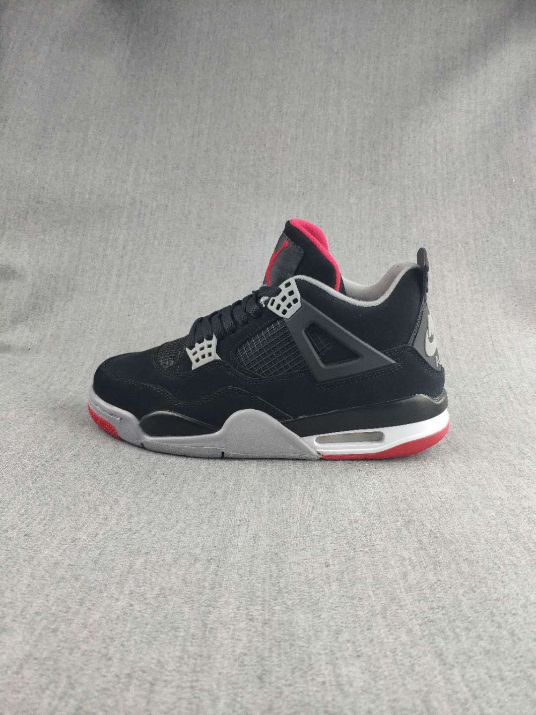 Jordan 4 Retro Sneaker in Black, in Red and White - product image from the listing.