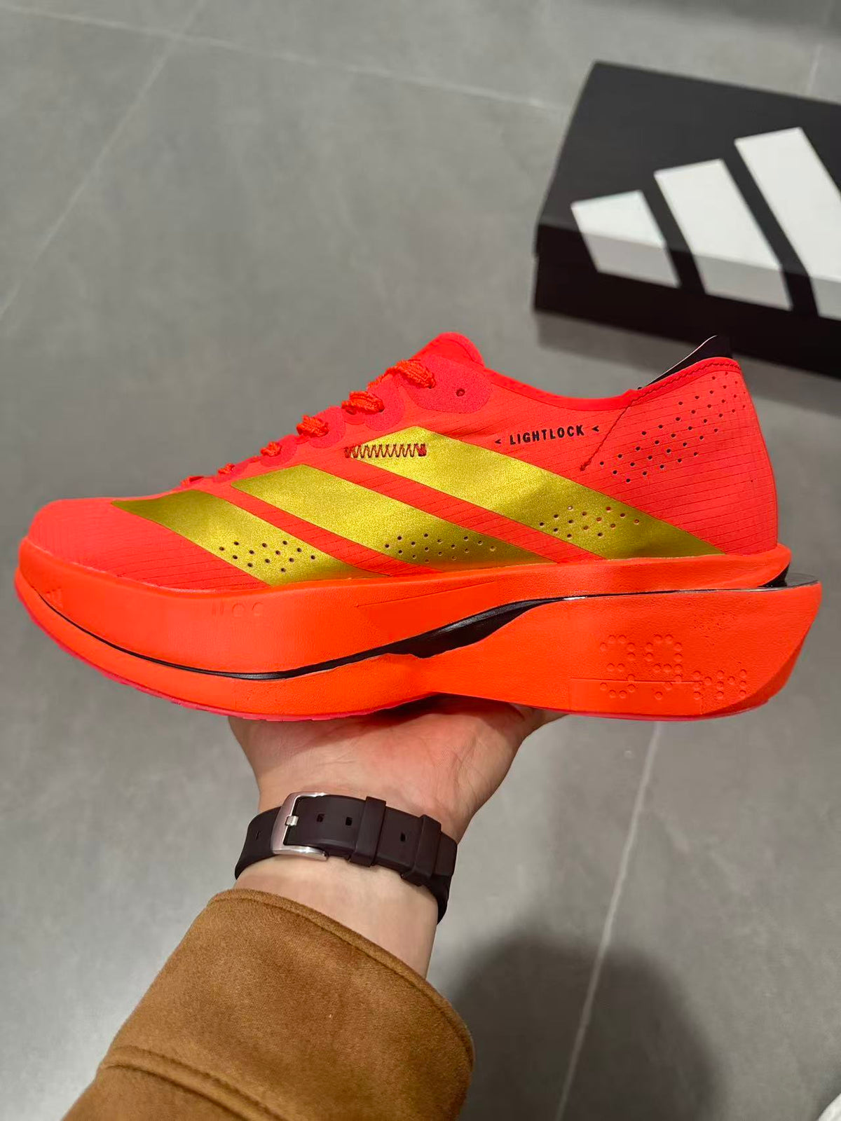 Adidas Adizero Adios Pro 5 Running Shoes, in Red and Lime - product image from the listing.