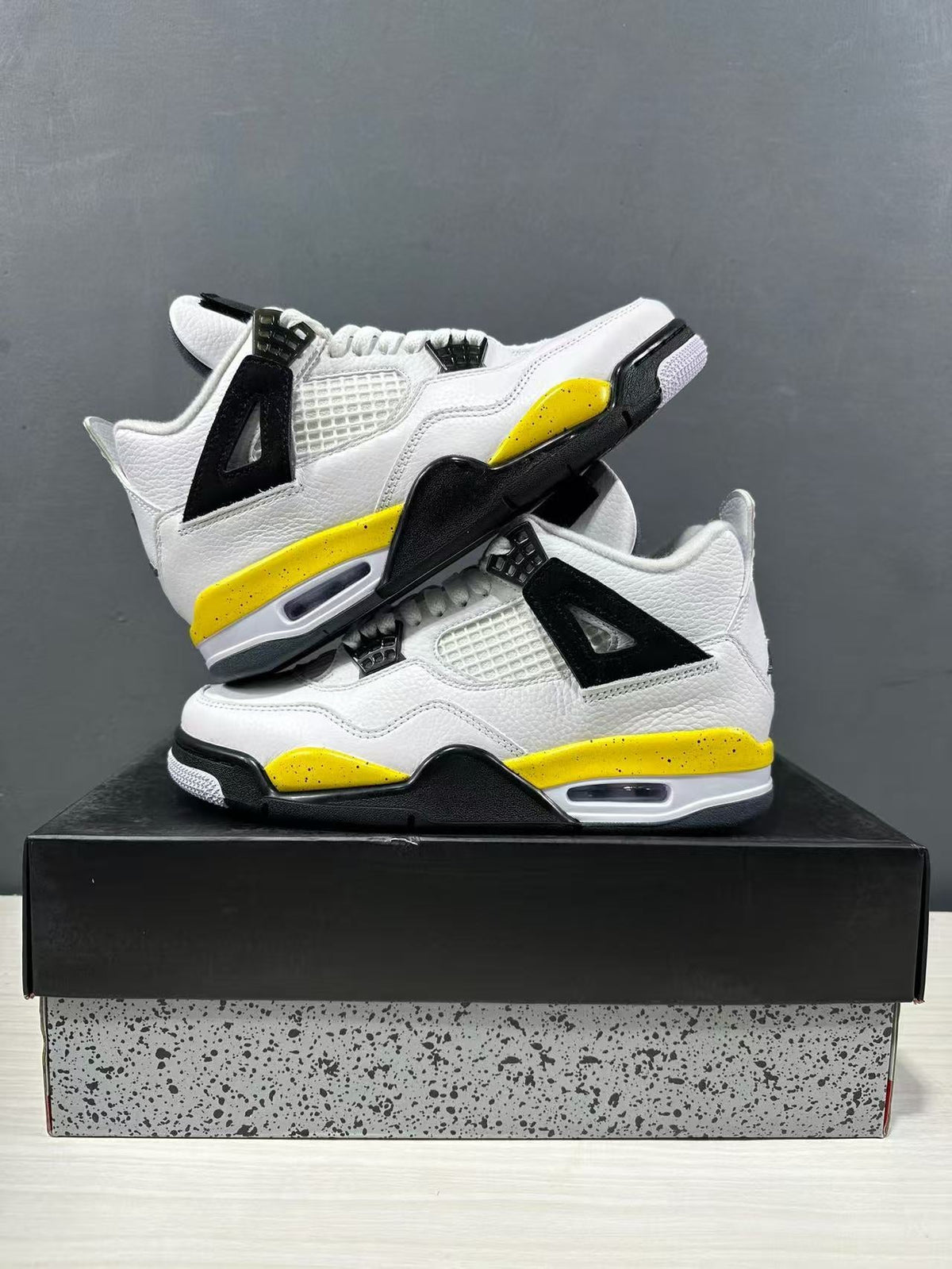 Air Jordan 4 Retro White Yellow Black Sneakers IO2468-102 - product image from the listing.