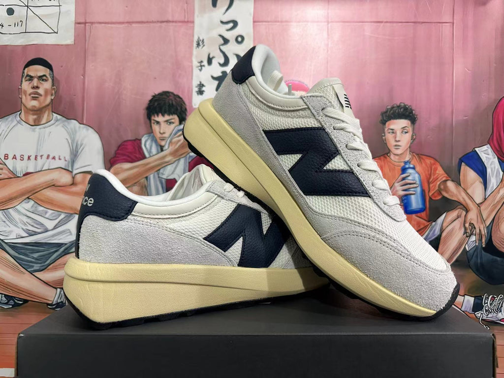 New Balance U370 Sneakers in Off-White and Black - product image from the listing.
