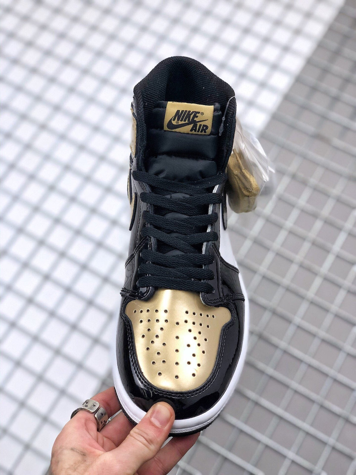 Air Jordan 1 High Gold Toe Sneakers in Black and Gold - product image from the listing.