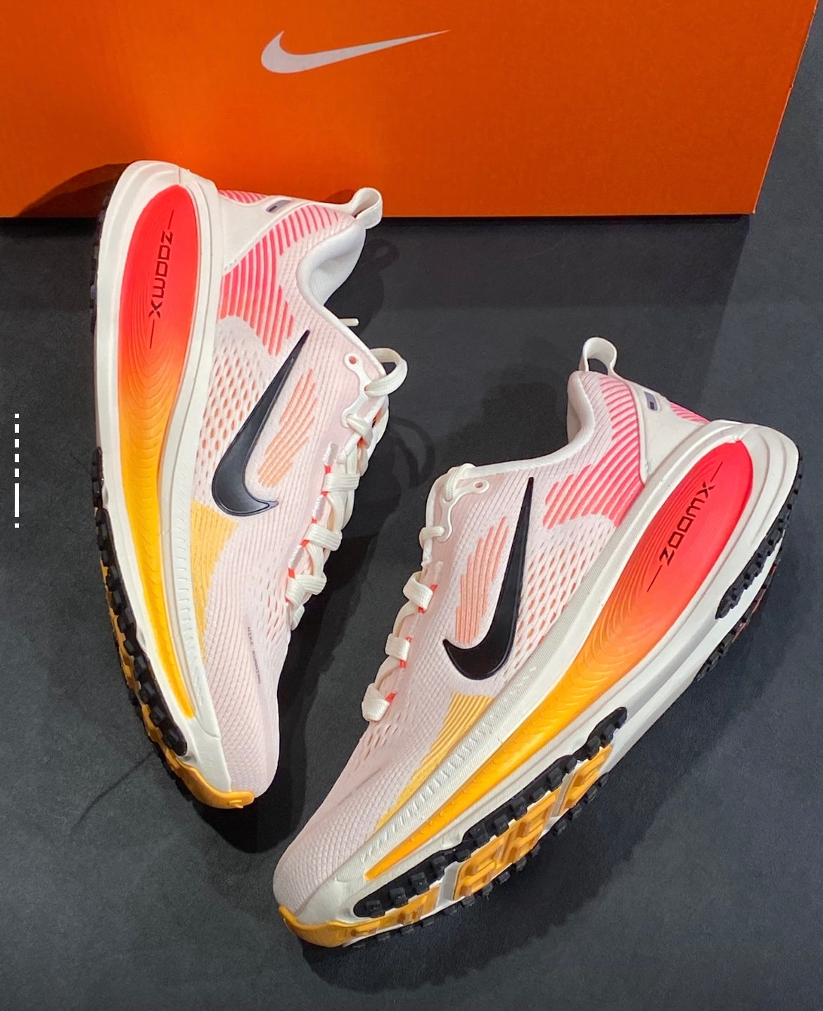 Nike Vomero 18 Running Shoes HM6804-100 in White Orange - product image from the listing.