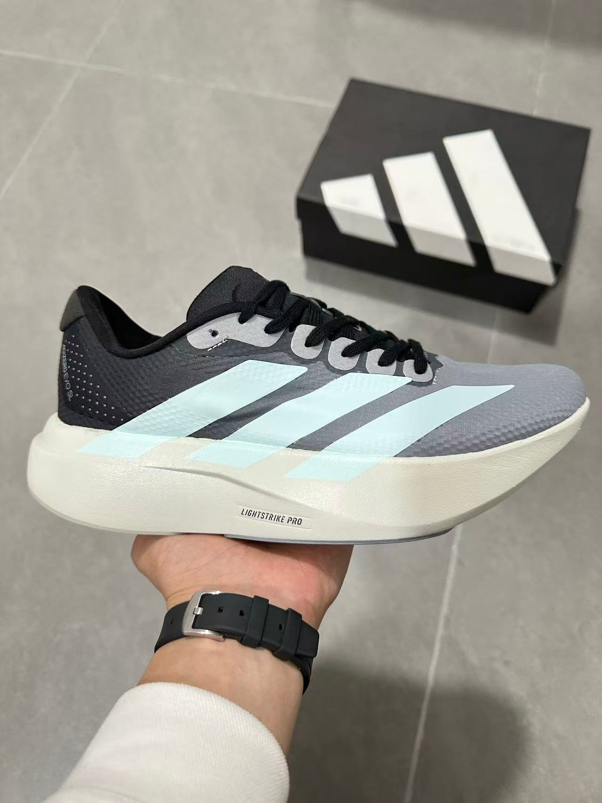 Gray and Blue Adidas Lightstrike Pro Running Shoes - product image from the listing.