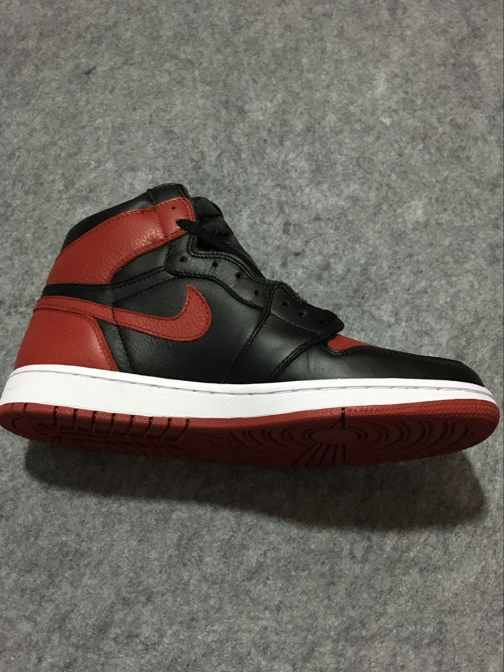Air Jordan 1 High Sneakers in Black and Red - product image from the listing.