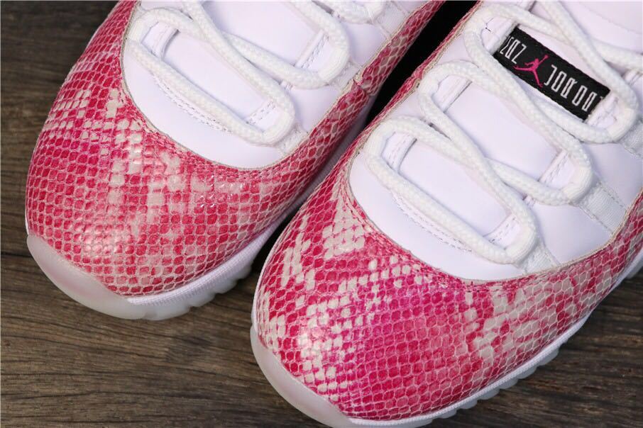 Women's Air Jordan 11 Retro Low Pink Snakeskin Sneakers - product image from the listing.
