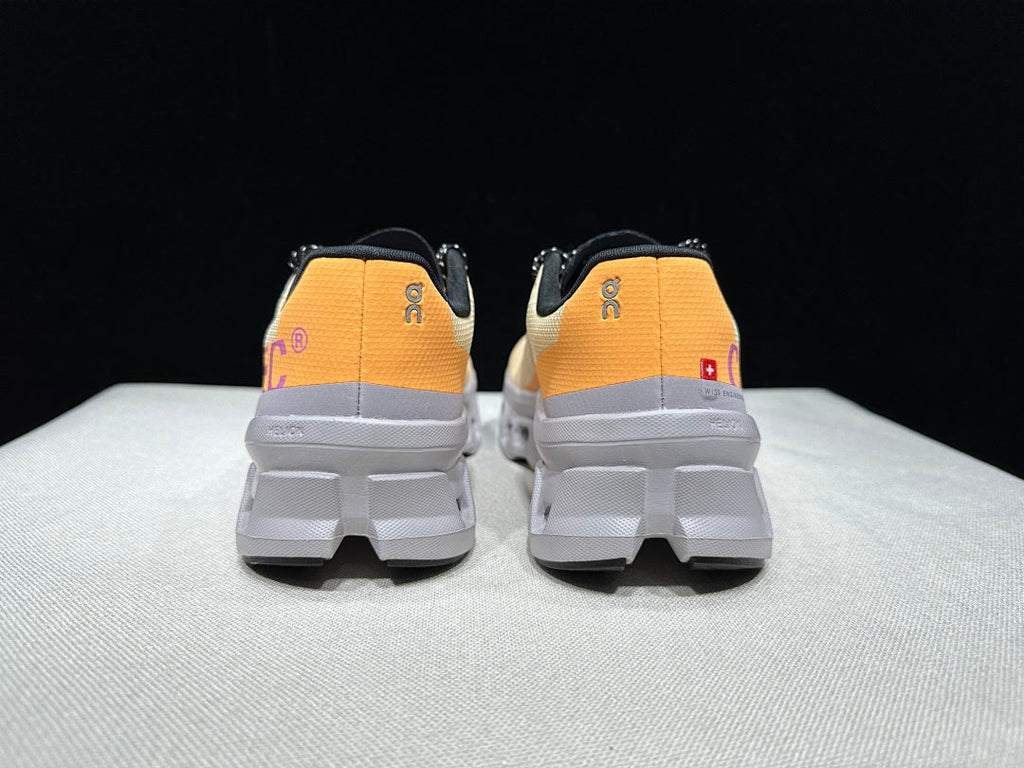 On Cloudmonster Running Shoes, in Pale Yellow and Orange - product image from the listing.