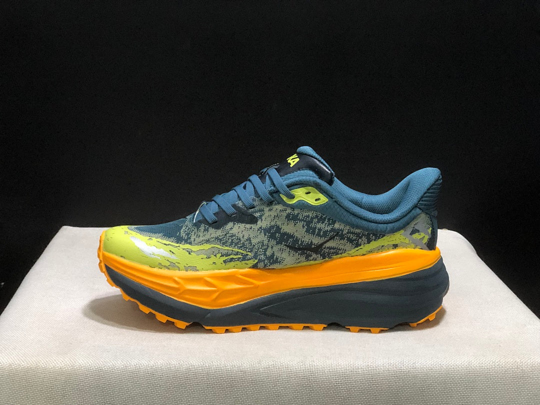 HOKA Stinson 7 Trail Running Shoes in Blue Yellow Orange - product image from the listing.