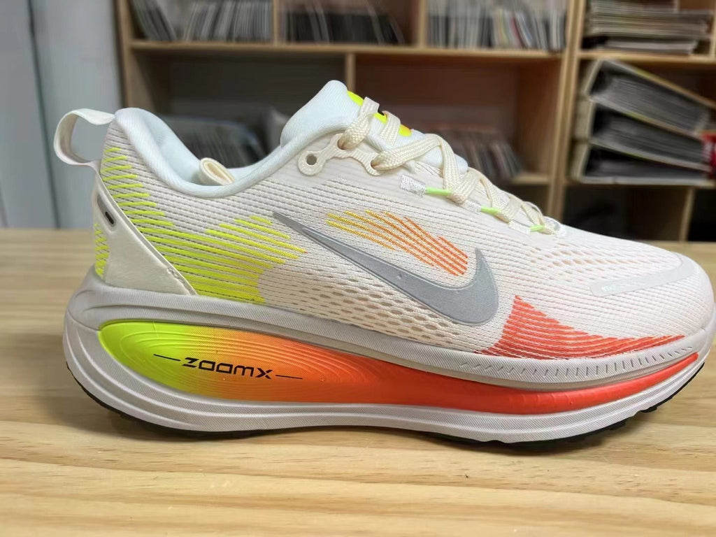 Nike Vomero 18 Running Shoes in White Volt Orange - product image from the listing.