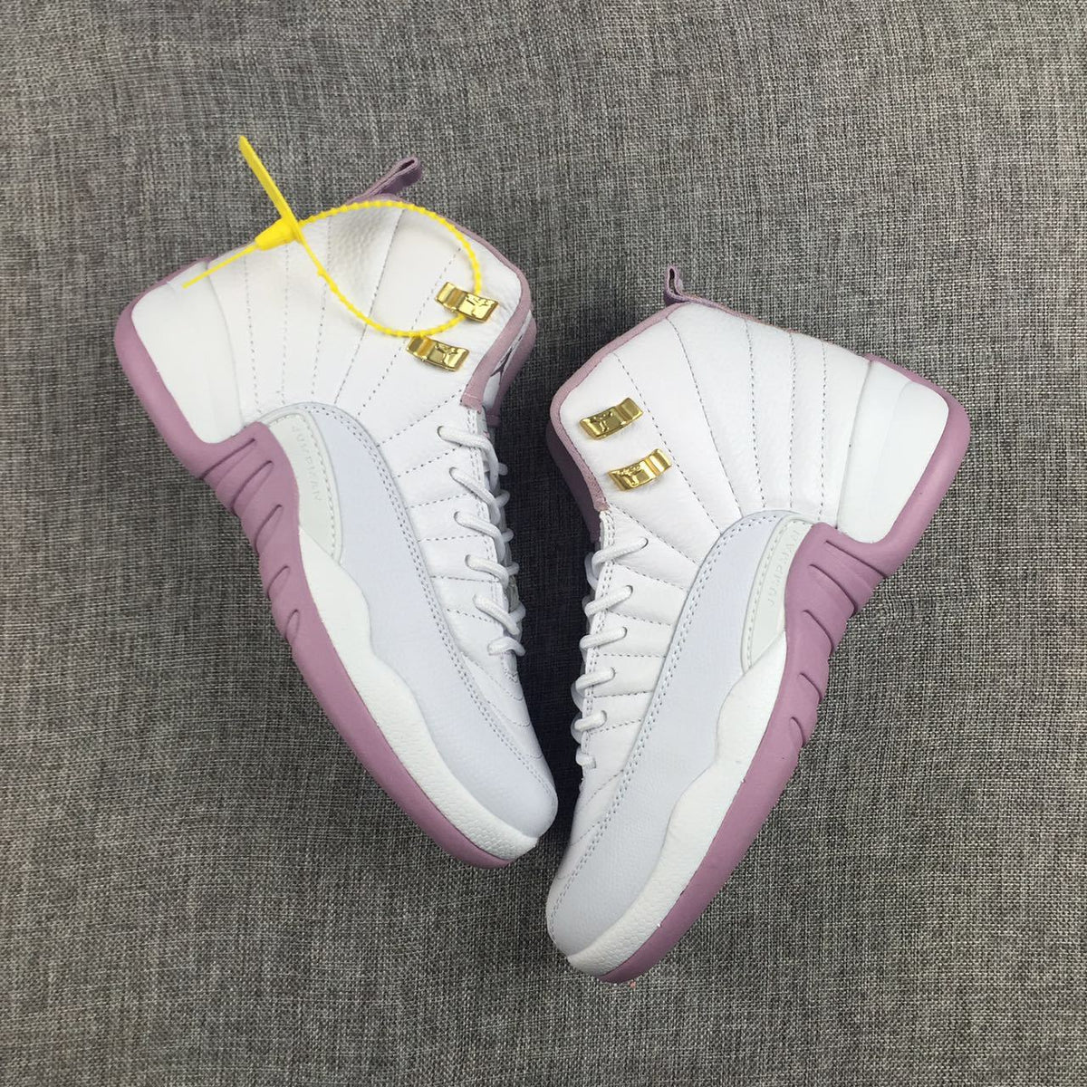 Air Jordan 12 Cherry Blossom Pink Sneakers - product image from the listing.