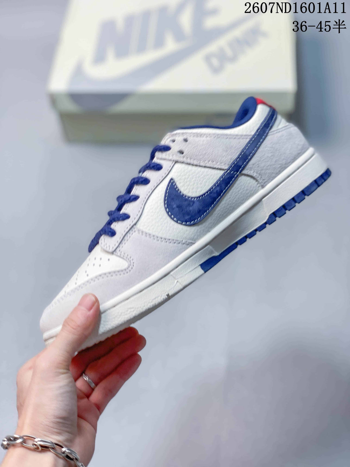 Nike SB Dunk Low Sneakers in White and Blue 2607ND1601A11 - product image from the listing.