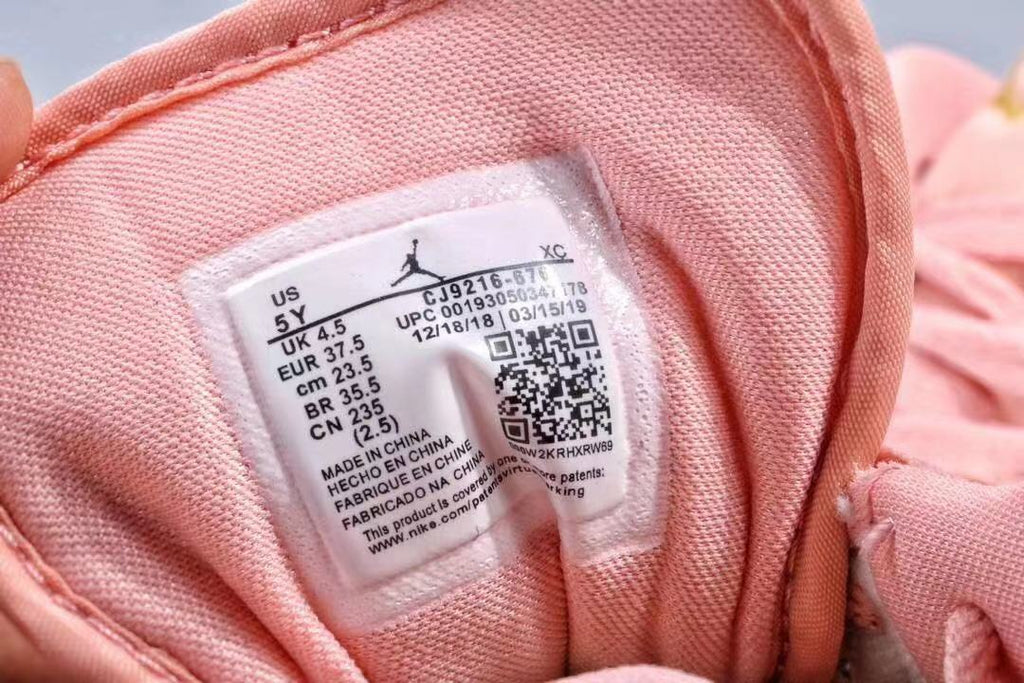 Women's Jordan 1 Low Pink and Gold Sneakers - product image from the listing.