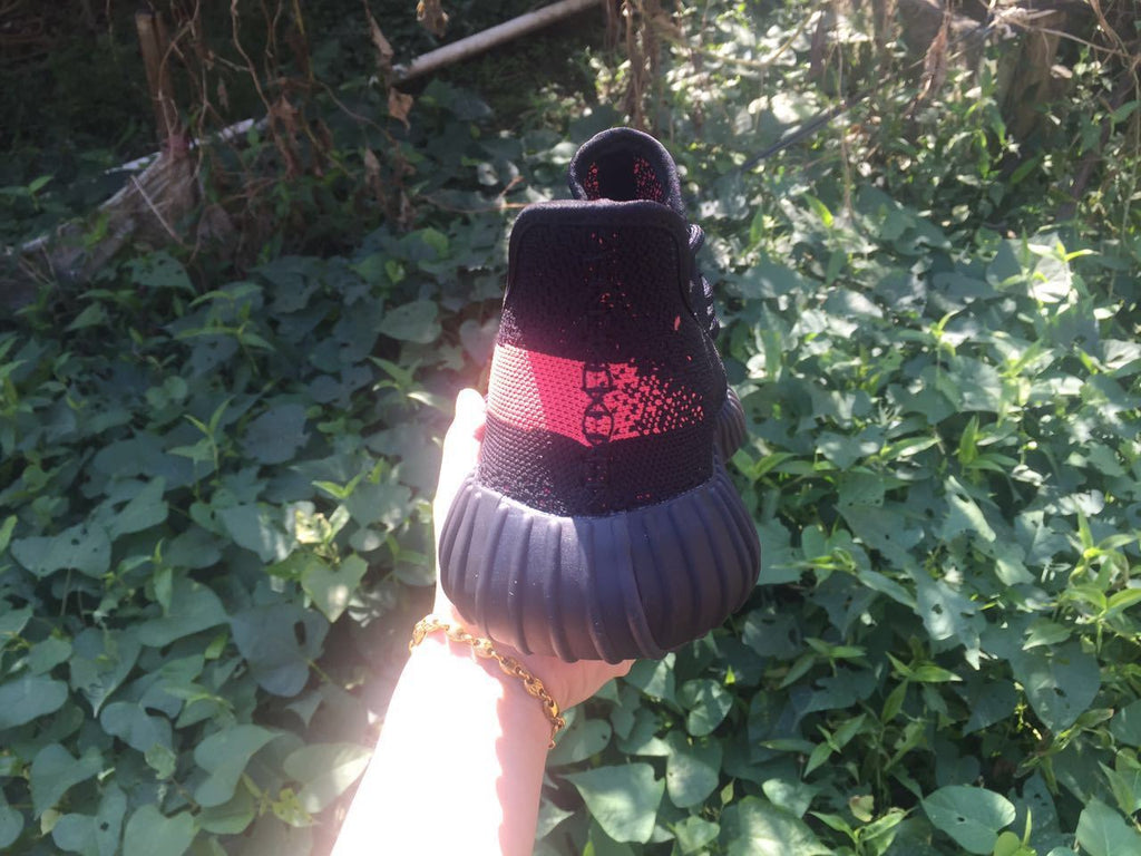Yeezy Boost 350 V2 Sneakers in Black and Bright Coral - product image from the listing.