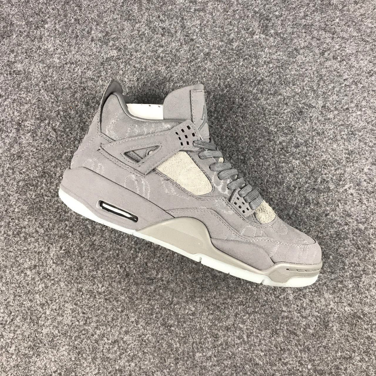 Grey Jordan 4 KAWS Sample High-Top Sneakers - product image from the listing.