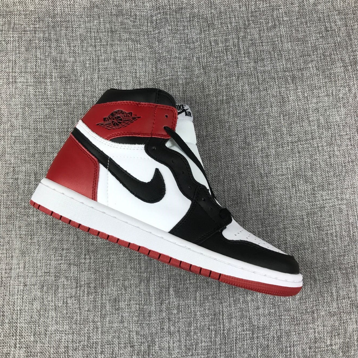 Black Toe Sneakers - Air Jordan 1 High 555088-184 - product image from the listing.