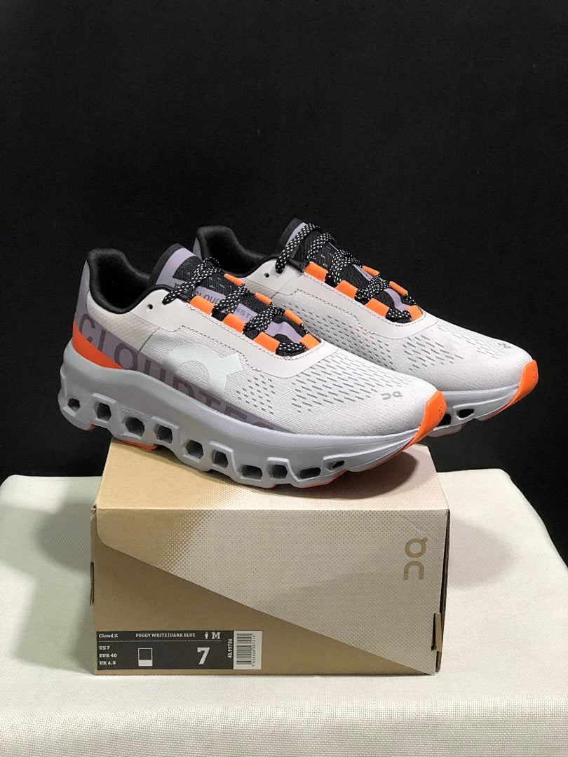 On Cloudmonster Sneakers in Foggy in White and Orange - product image from the listing.