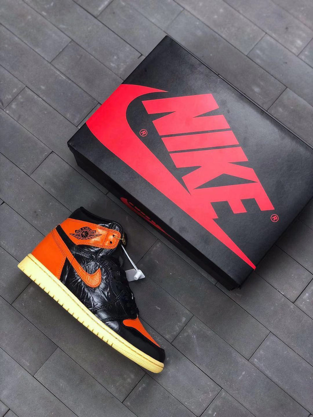 Air Jordan 1 Retro High OG Sneakers in Black and Orange - product image from the listing.