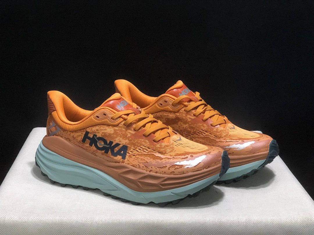 Orange HOKA Stinson 7 Trail Running Shoes - product image from the listing.