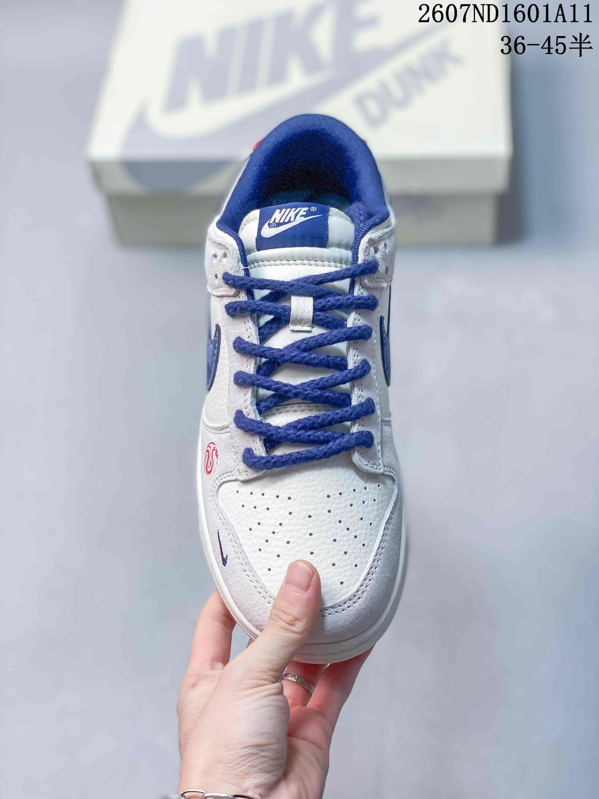 Nike SB Dunk Low Sneakers in White and Blue 2607ND1601A11 - product image from the listing.