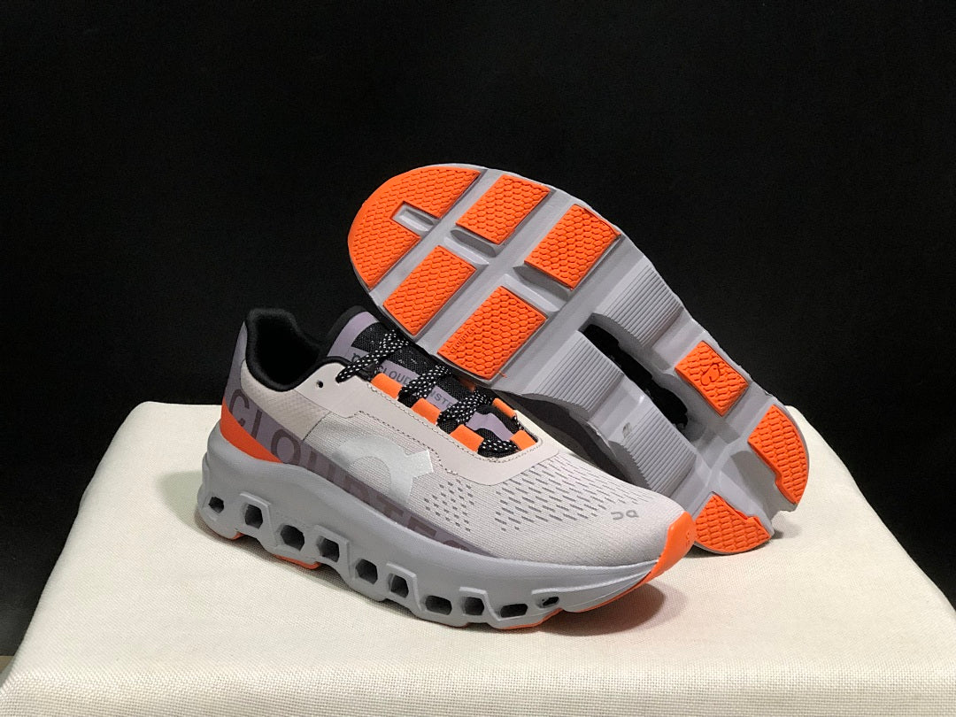 On Cloudmonster Sneakers in Foggy in White and Orange - product image from the listing.