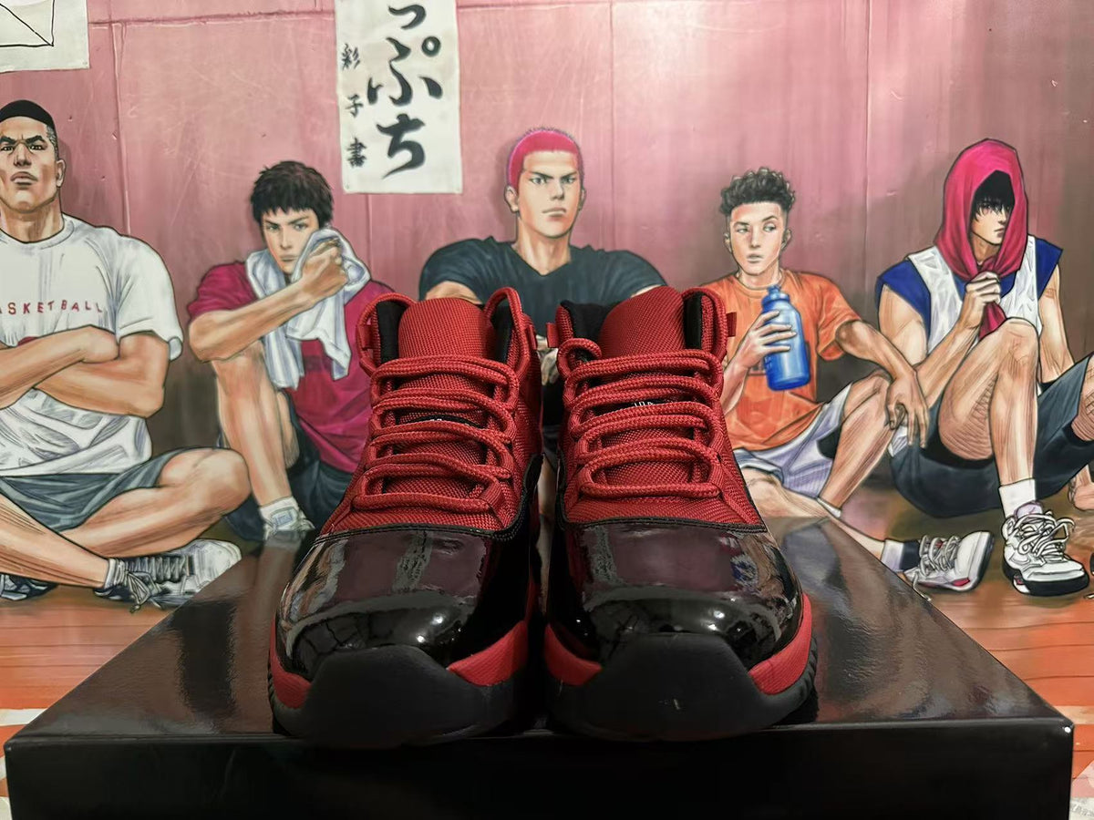 Jordan 11 High-Top Sneakers in Black and Red - product image from the listing.
