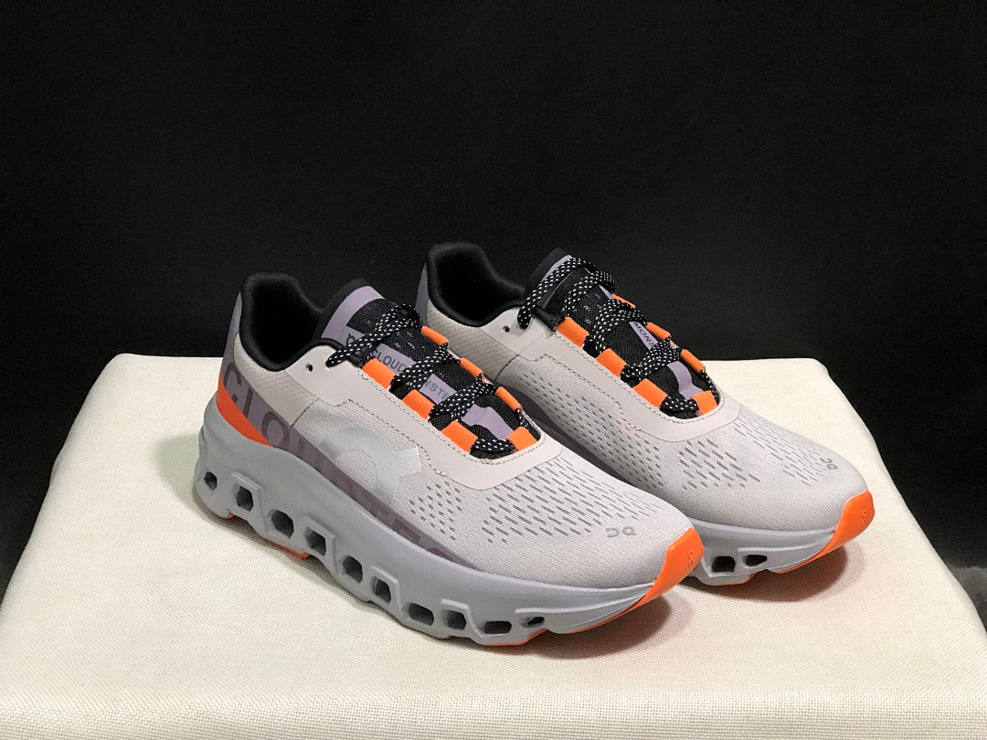 On Cloudmonster Sneakers in Foggy in White and Orange - product image from the listing.