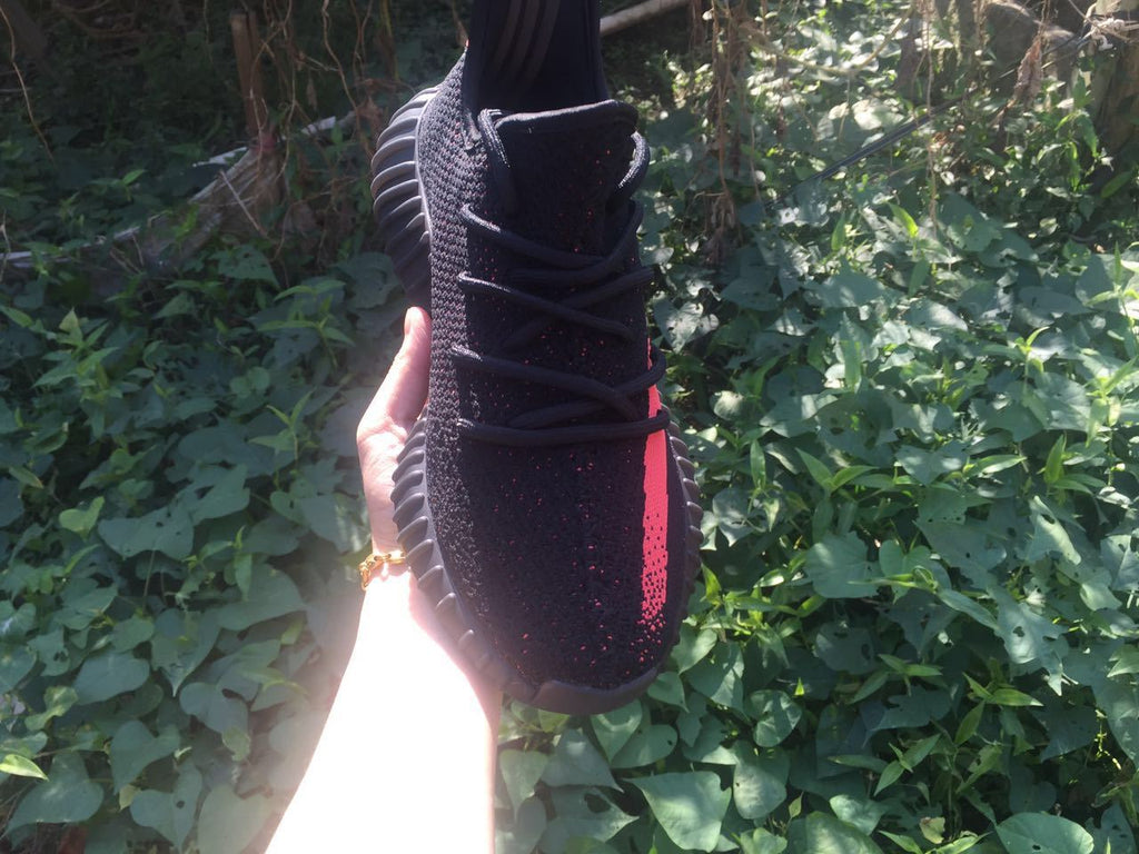 Yeezy Boost 350 V2 Sneakers in Black and Bright Coral - product image from the listing.