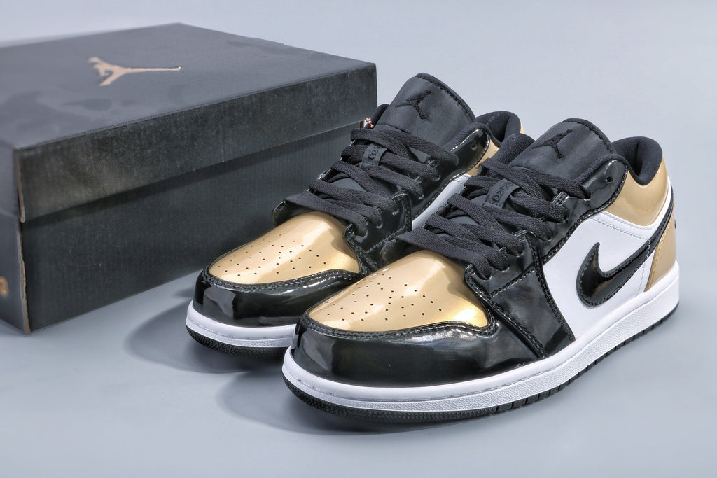 Jordan 1 Low Gold Toe Sneakers in Black and Metallic Gold - product image from the listing.