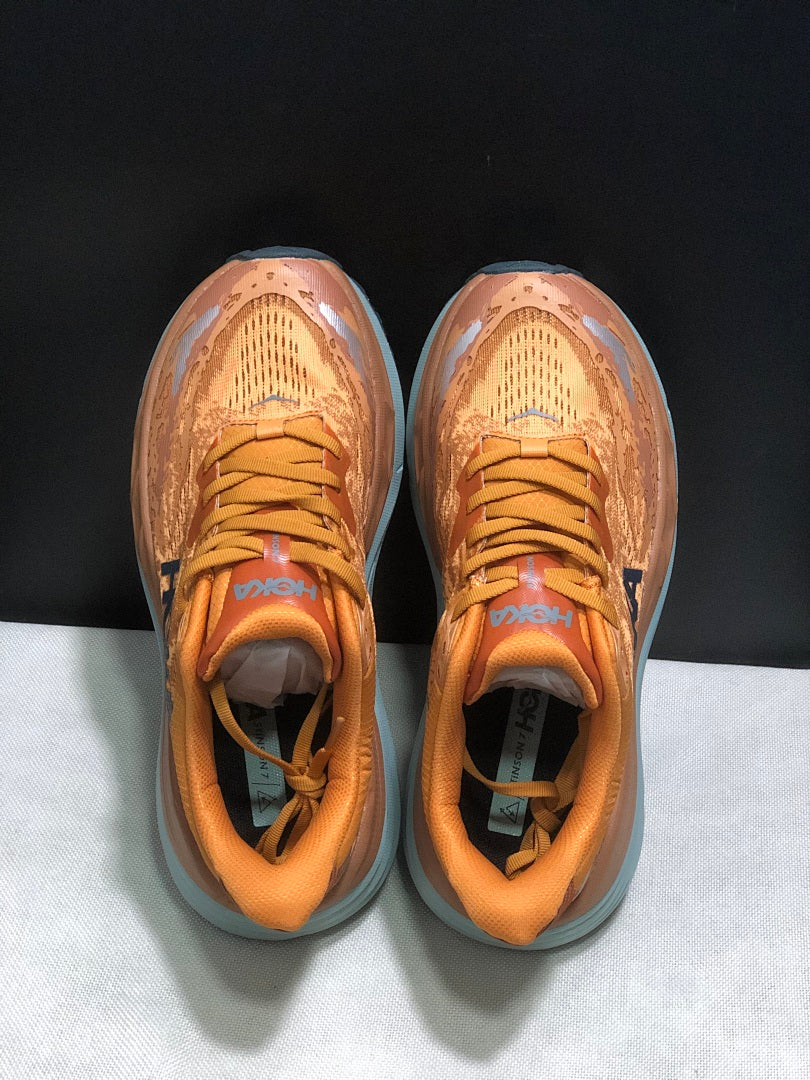 Orange HOKA Stinson 7 Trail Running Shoes - product image from the listing.