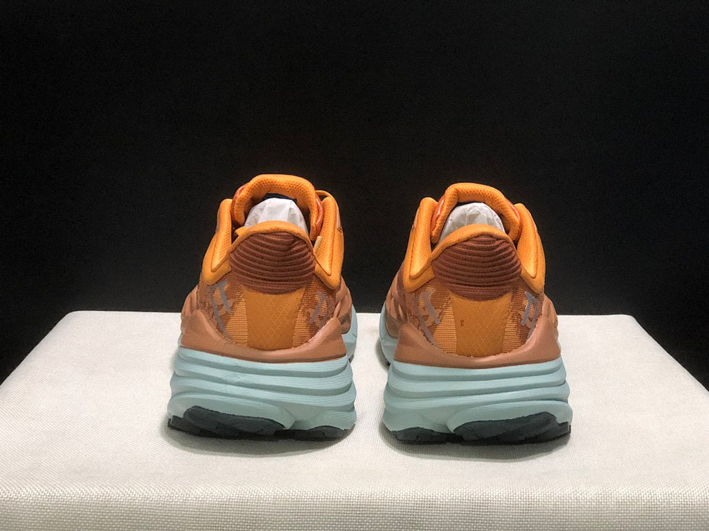 Orange HOKA Stinson 7 Trail Running Shoes - product image from the listing.