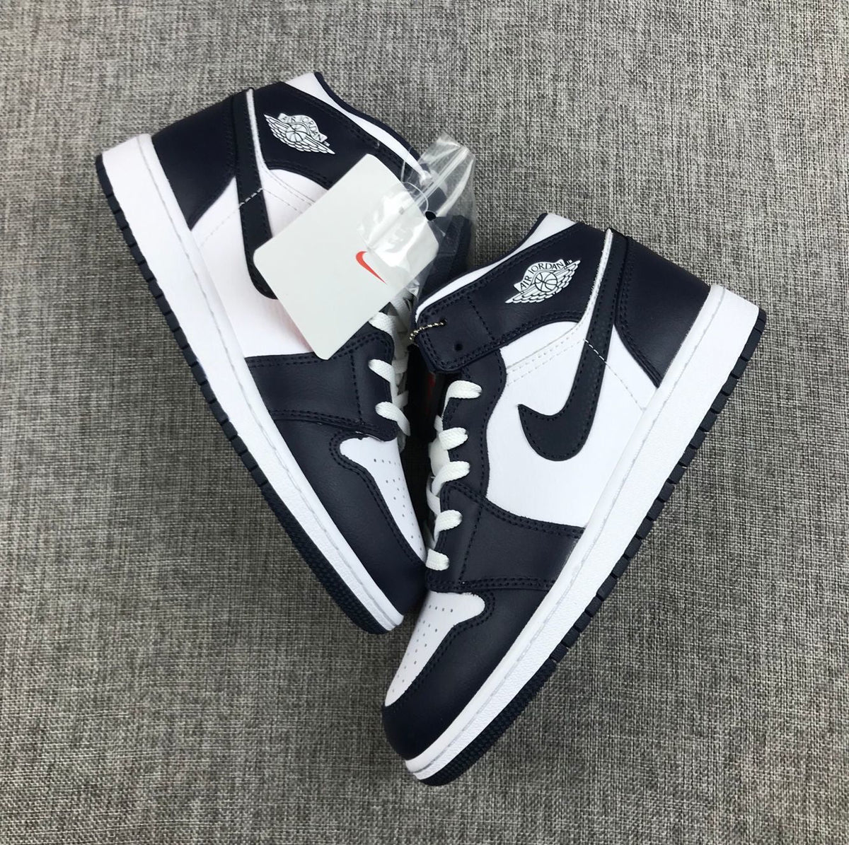 What The Obsidian Sneakers - Jordan 1 Mid 554724-174 - product image from the listing.