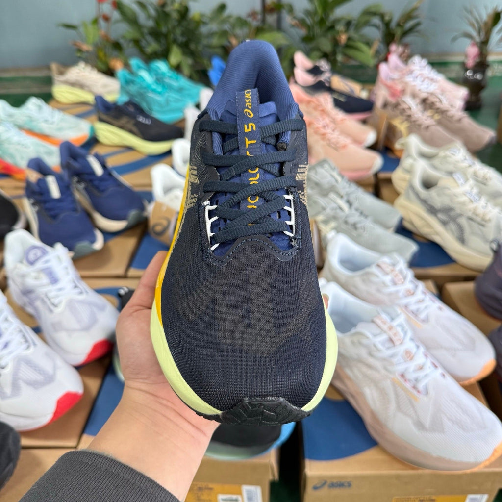 ASICS Novablast 5 LE Running Shoes in Dark Blue Yellow - product image from the listing.