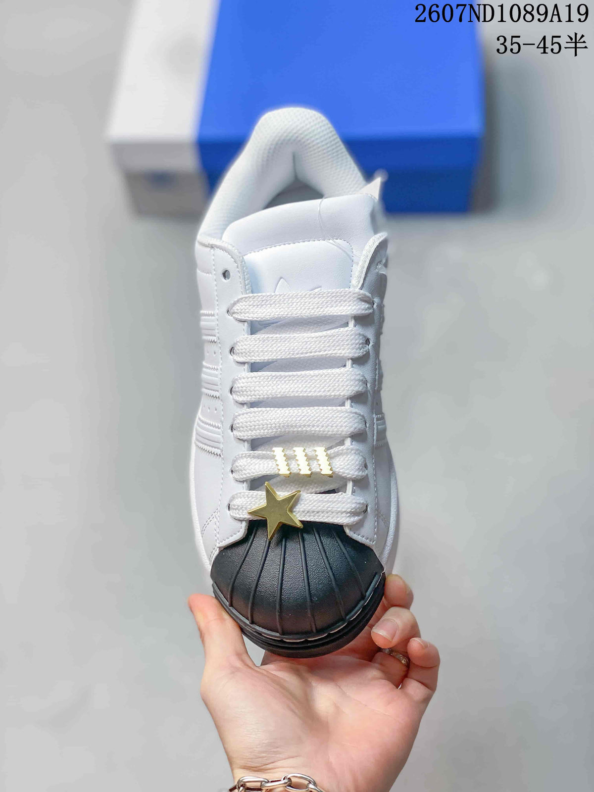 Adidas Superstar Sneakers in White Black Gold 2607ND1089A19 - product image from the listing.