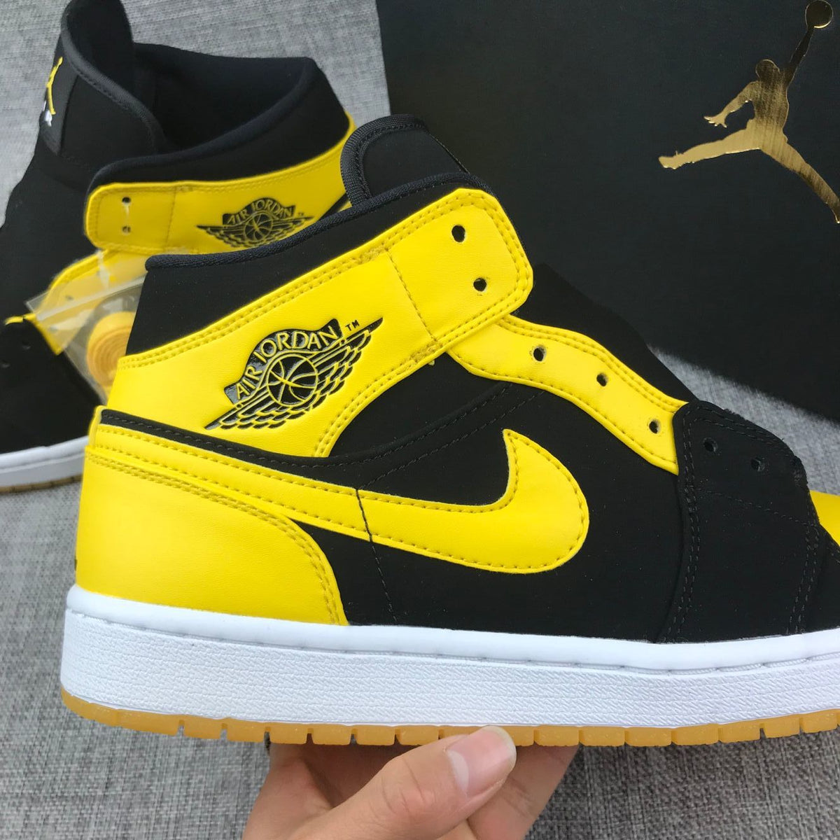 Air Jordan 1 Mid Sneakers in Black and Yellow - product image from the listing.