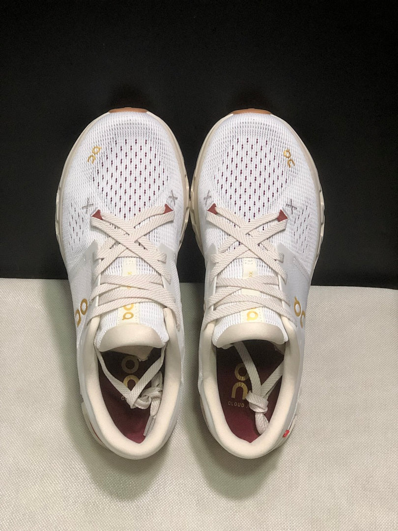 On Cloud X 4 Year of the Snake Sneakers in Ivory Cream - product image from the listing.