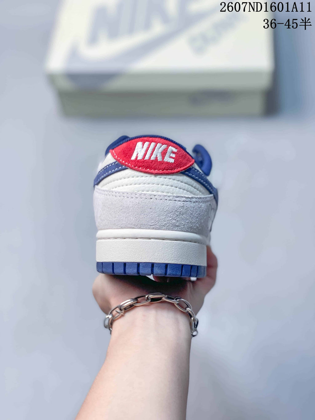 Nike SB Dunk Low Sneakers in White and Blue 2607ND1601A11 - product image from the listing.