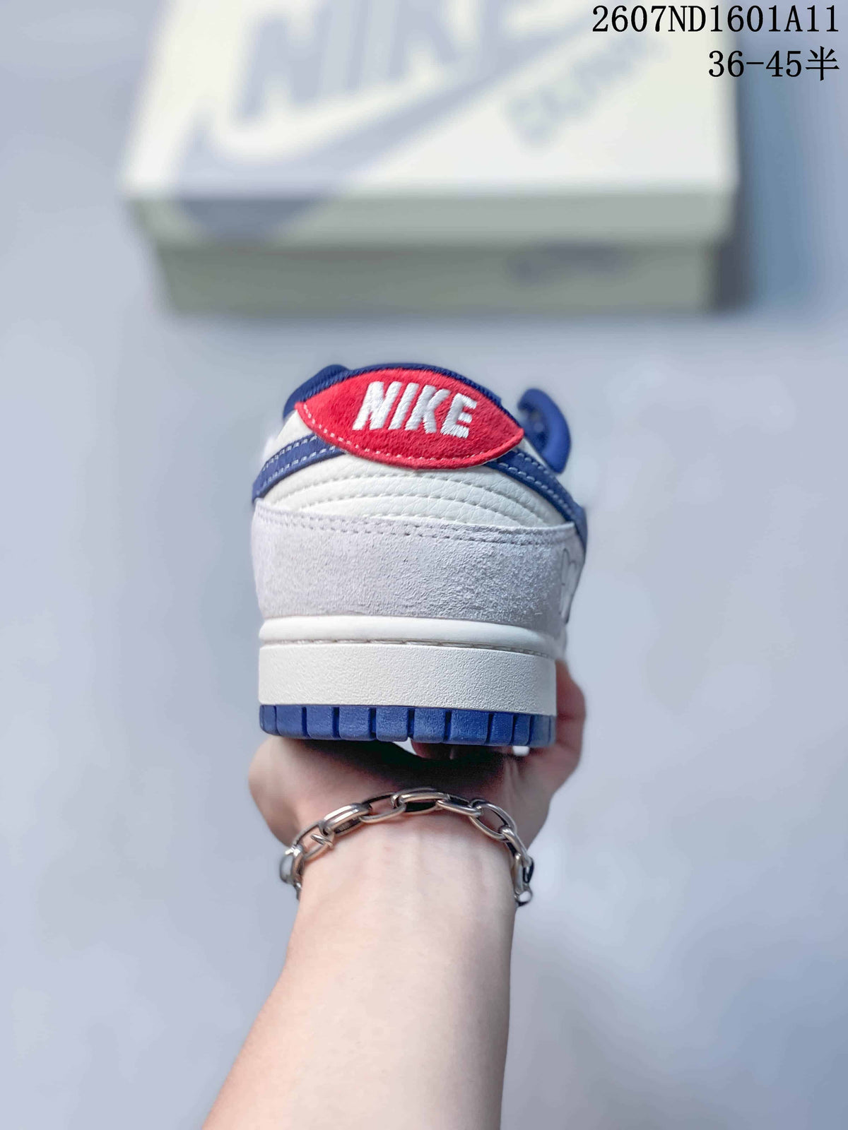 Nike SB Dunk Low Sneakers in White and Blue 2607ND1601A11 - product image from the listing.