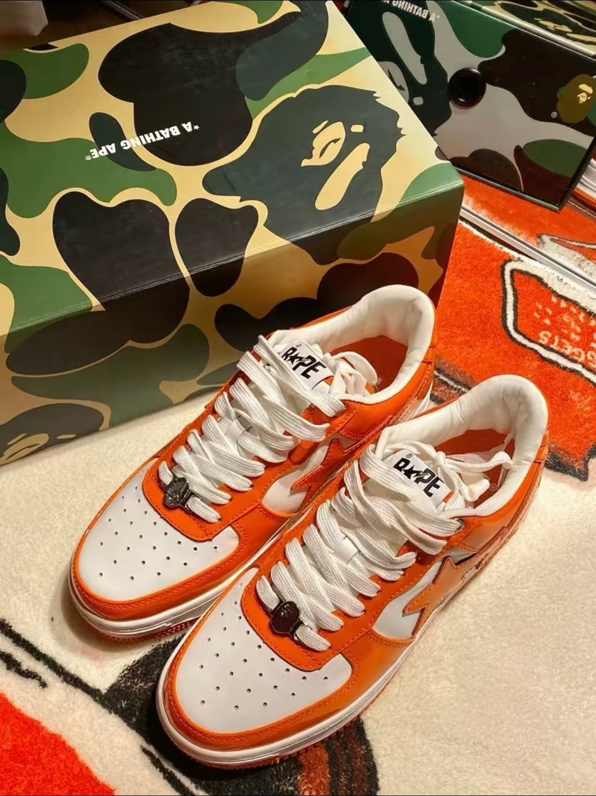 A Bathing Ape BAPE STA Low Sneakers in White Orange - product image from the listing.