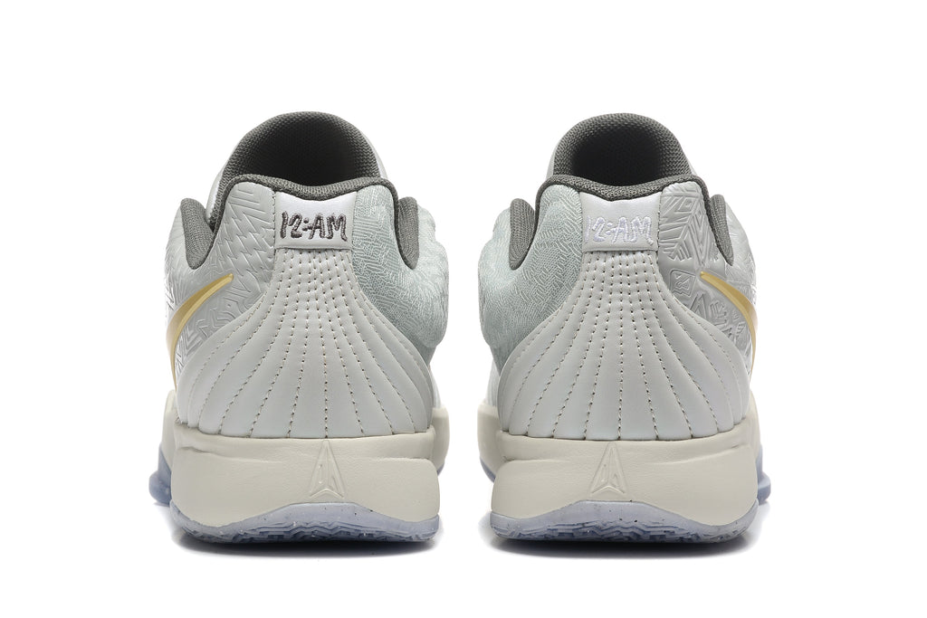 Gray and Gold Nike Kyrie Low Basketball Shoes - product image from the listing.