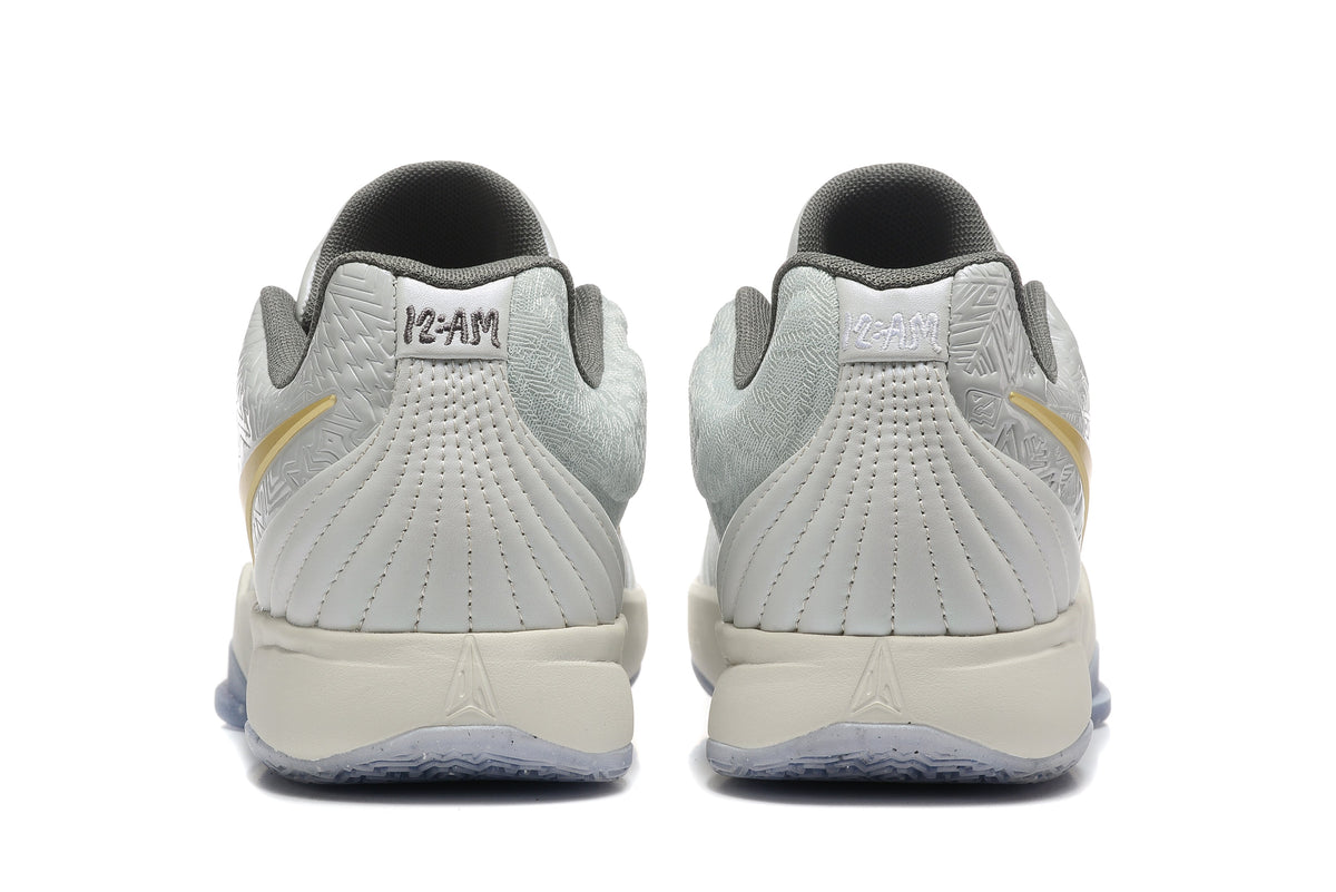 Gray and Gold Nike Kyrie Low Basketball Shoes - product image from the listing.