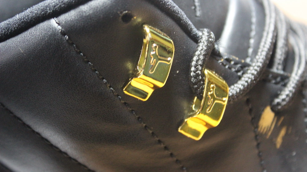 Air Jordan 12 Wings Black White Gold Sneakers 848692-033 - product image from the listing.