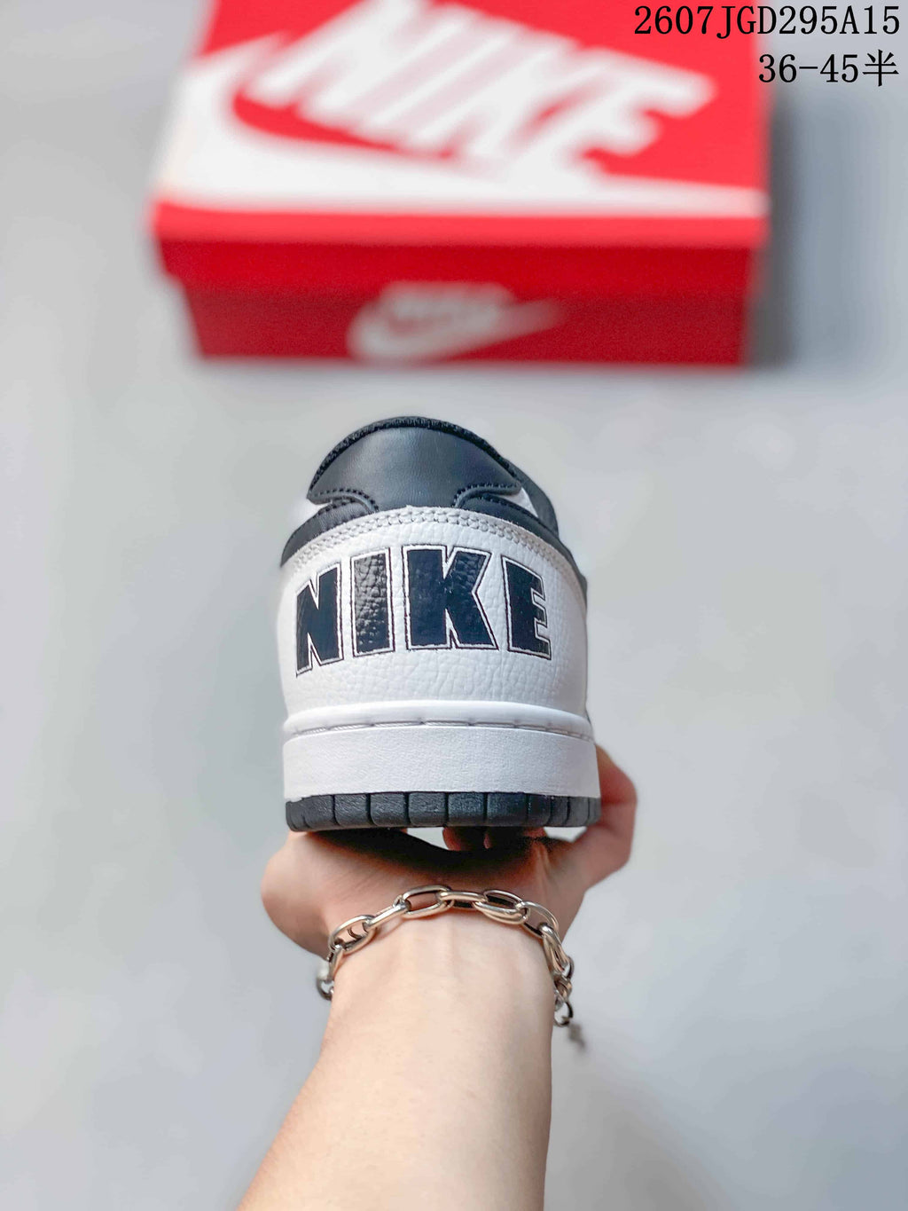 Nike SB Dunk Low Pro Sneakers in White Black 2607TGD295A15 - product image from the listing.