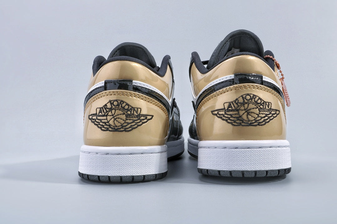 Jordan 1 Low Gold Toe Sneakers in Black and Metallic Gold - product image from the listing.