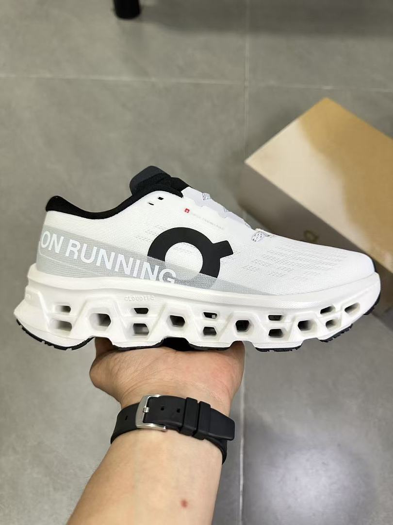 On Running Running Shoes in White and Black - product image from the listing.