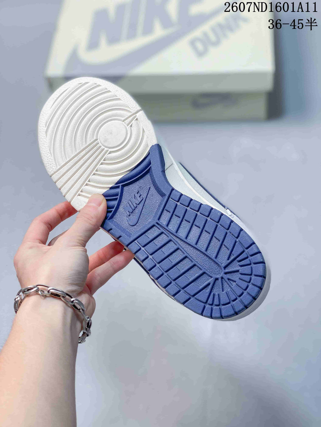 Nike SB Dunk Low Sneakers in White and Blue 2607ND1601A11 - product image from the listing.